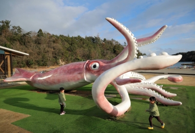 Children play around the giant Squid King statue in the town of Noto, Ishikawa Prefecture, on Feb. 27.