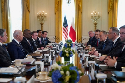 Poland's Prime Minister Donald Tusk (right, center) speaks next to Poland's President Andrzej Duda (right, second from right) during a meeting with U.S. President Joe Biden (left, second from left), at the White House in Washington on Tuesday.