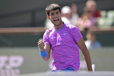 Carlos Alcaraz pumps his first after winning a point against Fabian Marozsan as the defending champion moved into the Indian Wells quarterfinals on Tuesday. 