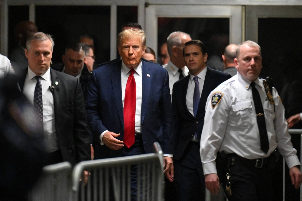 Former U.S. President Donald Trump arrives to speak to the press at Manhattan Criminal Court after a hearing in his case of paying hush money to cover up extramarital affairs, in New York City on Feb. 15.