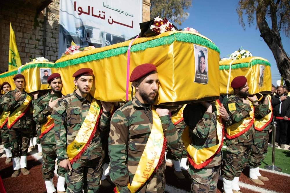 Hezbollah members take part in the funeral of four members of one family killed by in an Israeli air raid in southern Lebanon, on March 11 in Blida, near the border with Israel.
