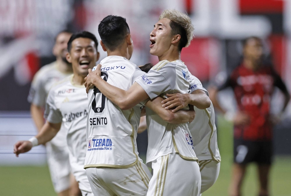 Machida Zelvia players celebrate after a goal in the team's 2-1 win away at Consadole Sapporo on Saturday.