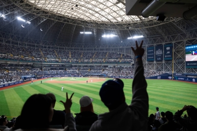Fans cheer during a friendly match between the Los Angeles Dodgers and the Kiwoon Heroes ahead of the Major League Baseball Seoul Series in Seoul on Sunday.
