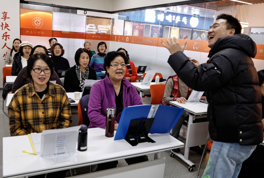 Women attend a singing class at Mama Sunset, a learning center for middle-aged and senior people, in Beijing in January.