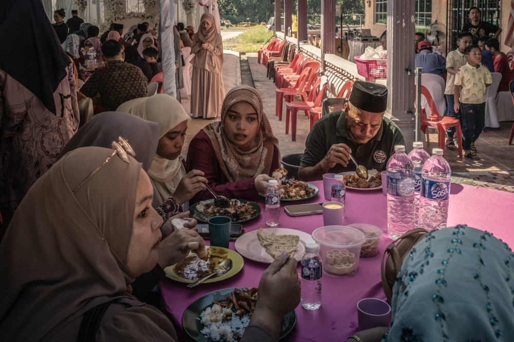 Attendees gathered for a wedding ceremony inside a village surrounded by palm plantations, in Membakut, Malaysia, on Feb. 11. Nearly 4.5 million people in Malaysia and Indonesia are employed in the palm oil industry. 
