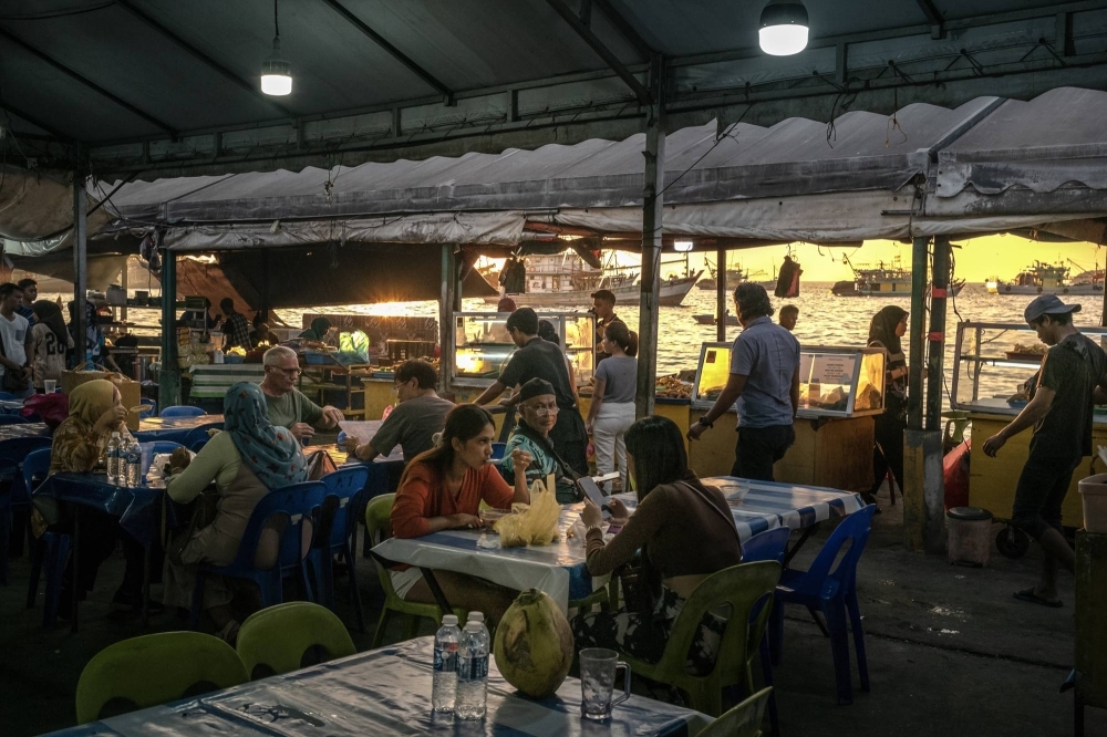 Diners at a market in Kota Kinabalu, Malaysia on Feb. 19. One acre of palm oil can produce four to 10 times as much oil as the same area of soybeans, rapeseed or sunflowers. 