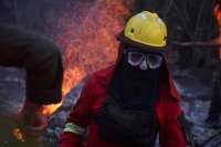 A firefighter tackles a fire in a sugar field in San Buenaventura, Bolivia, in November 2023. | REUTERS