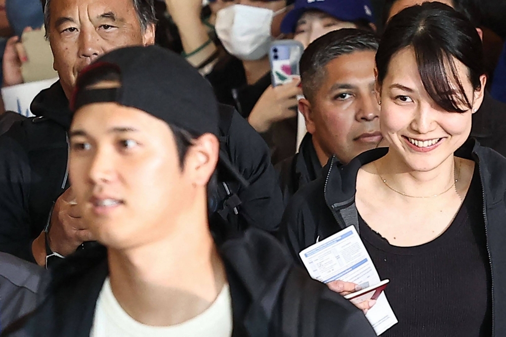 Mamiko Tanaka (right), wife of Los Angeles Dodgers Shohei Ohtani, arrives at Incheon International Airport on Friday ahead of the 2024 MLB Seoul Series baseball games.