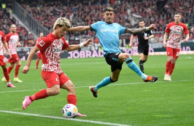 Freiburg's Ritsu Doan (left) and Bayer Leverkusen's Exequiel Palacios vie for the ball during a German first division Bundesliga soccer match in Freiburg, Germany, on Sunday.