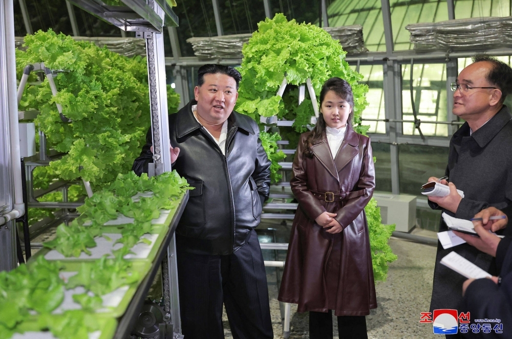 North Korean leader Kim Jong Un and his daughter visit the Gangdong Comprehensive Greenhouse in Pyongyang.