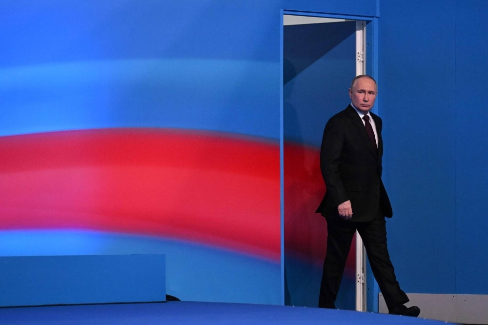 Russian President Vladimir Putin meets with the media at his campaign headquarters in Moscow on Monday. 