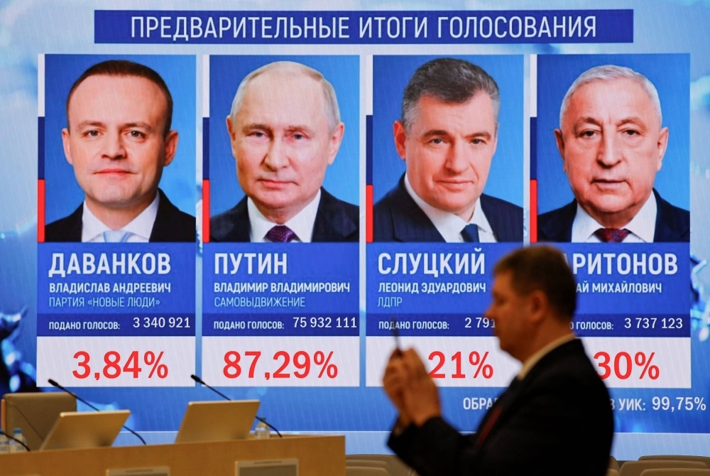 A screen at the headquarters of the Central Election Commission in Moscow shows the preliminary results of Russia's presidential election on Monday.