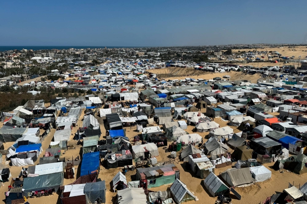 Displaced Palestinians, who fled their houses due to Israeli strikes, shelter in a tent camp in Rafah, in the southern Gaza Strip this month.