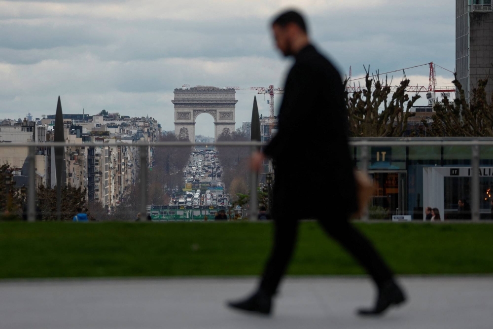 A man walks through the financial and business district of La Defense, near Paris, on March 13.