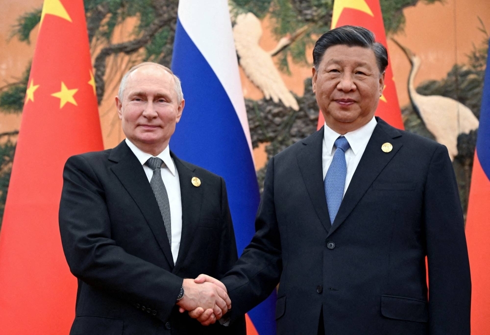 Russian President Vladimir Putin shakes hands with Chinese President Xi Jinping during a meeting at the Belt and Road Forum in Beijing in October last year.