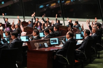 Lawmakers vote on the new national security law at Hong Kong’s Legislative Council on Tuesday.