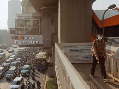 A commuter walks along an overpass in Jakarta.