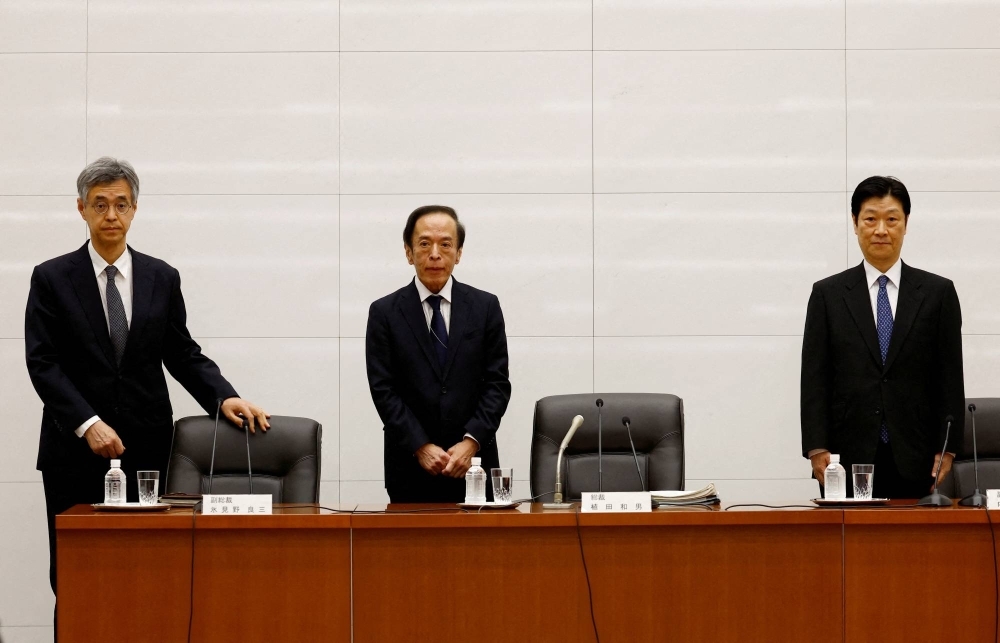 Bank of Japan Gov. Kazuo Ueda (center) and Deputy Govs. Ryozo Himino (left) and Shinichi Uchida (right) attend a news conference at the bank headquarters in Tokyo in April 2023