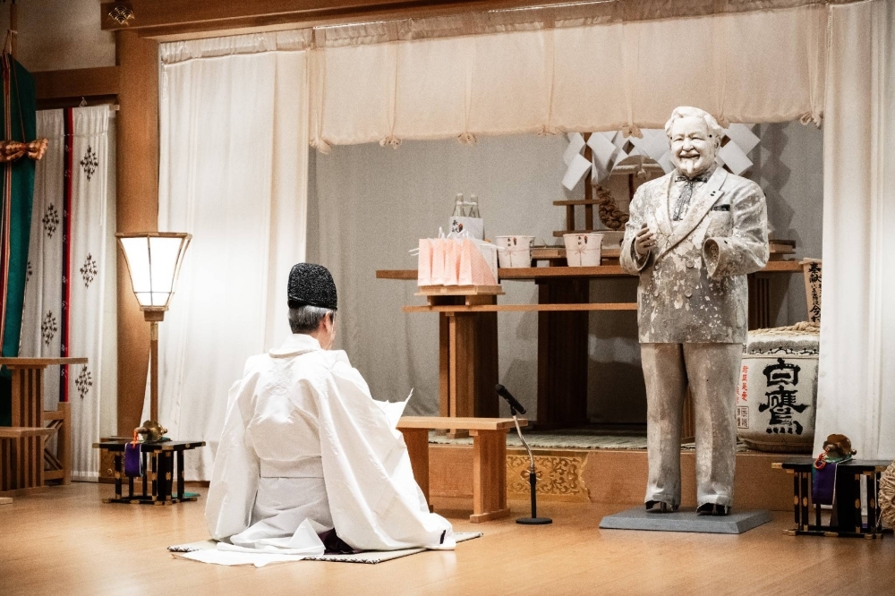 A statue of Kentucky Fried Chicken founder Colonel Harland Sanders going through a ritual that is typically held for the repose of the souls of old dolls at Sumiyoshi Taisha shrine in Osaka.