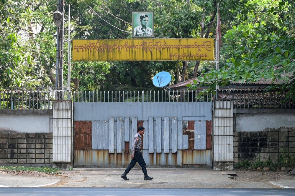 A police officer walks outside the entrance of the family house of detained Myanmar civilian leader Aung San Suu Kyi in Yangon, Myanmar, on Wednesday.