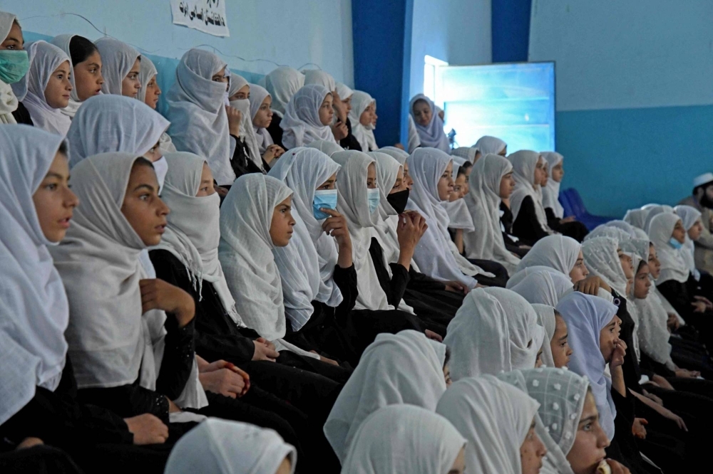 Afghan schoolgirls in 2022. Boys and men will return to classes when the Afghan new year starts in late March, but girls and women will be left behind again by a Taliban government education blockade that is part of a raft of restrictions the United Nations has labelled "gender apartheid."