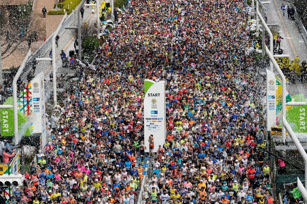 Runners fill the street in front of the Tokyo Metropolitan Government Building at the start of the 2023 Tokyo Marathon.