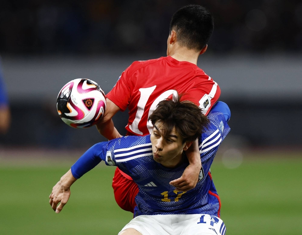 Japan's Ao Tanaka in action with North Korea's Yu-Song Kim during Samurai Blue's win over North Korea in World Cup qualifying on Thursday in Tokyo. 