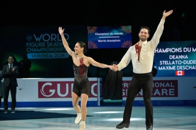Canadians Deanna Stellato-Dudek and Maxime Deschamps celebrate their gold-medal performance in the pairs competition at the World Figure Skating Championships in Montreal on Thursday. 