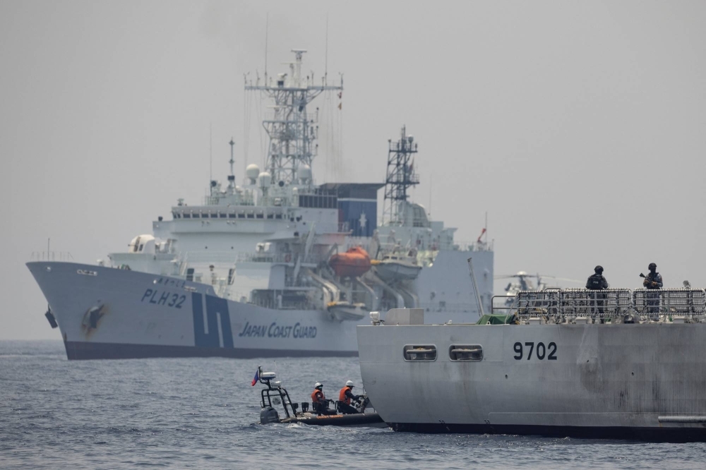 Philippine Coast Guard's BRP Melchora Aquino and Japan Coast Guard's Akitsushima participate in the first trilateral coast guard exercise between the Philippines, Japan and the United States, at the coast of Bataan, Philippines in the South China Sea, in June.