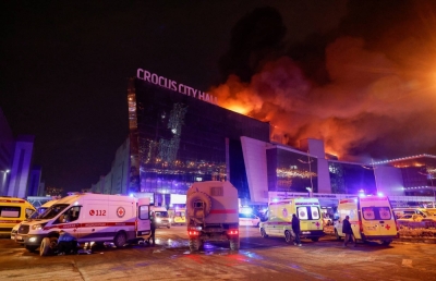 Russian emergency services vehicles are parked near the burning Crocus City Hall concert venue following a mass shooting claimed by the Islamic State group outside Moscow on Friday.