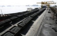 Containers transporting coal at a dock in Cam Pha, Vietnam. Enthusiasm for Vietnam’s renewables boom is dampened by factors such as its underdeveloped electricity grid and patchy regulatory framework, while the country’s major source of electricity remains coal. | Reuters