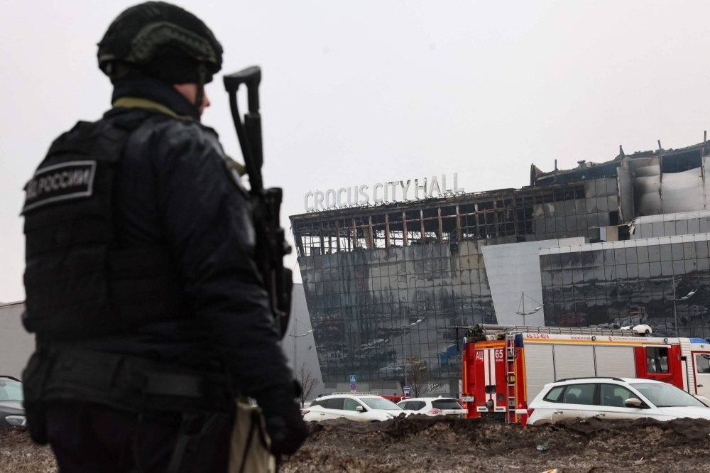 A law enforcement officer patrols the scene of the deadly attack at the Crocus City Hall concert hall in Krasnogorsk, outside Moscow, on Saturday.