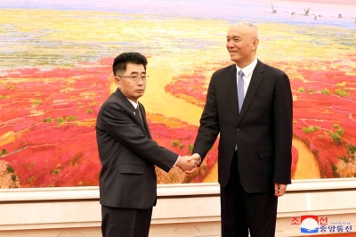 North Korea's Kim Song Nam, head of the International Department of the Workers' Party of Korea, and Cai Qi, head of the Secretariat of the Chinese Communist Party, meet in Beijing on Friday.
