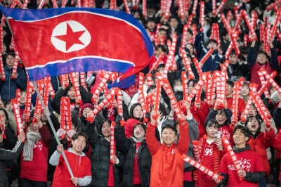 North Korean fans cheer on the national team during a World Cup qualifying match against Japan on Thursday in Tokyo. 
