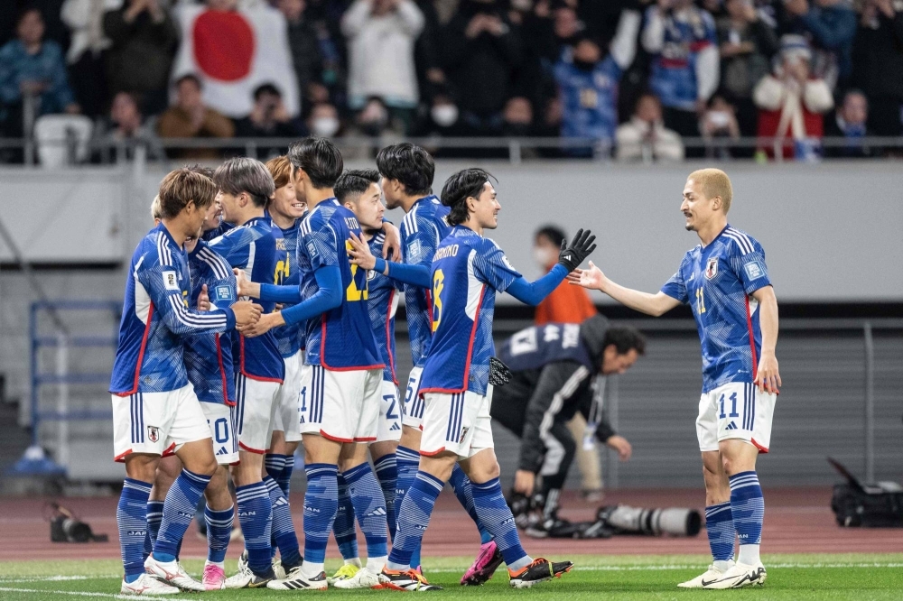 Japanese players celebrate a goal during their World Cup qualifying match against North Korea on Thursday in Tokyo. 
