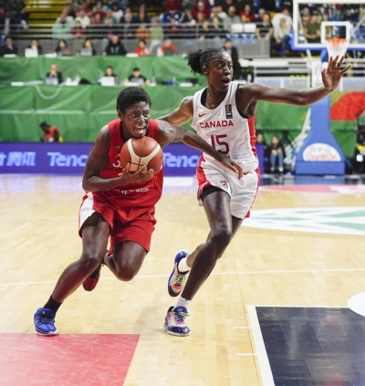 Japan's Evelyn Mawuli (left) goes on the attack as Canada's Laeticia Amihere plays defense in the first quarter of an Olympic women's basketball qualifier on Feb. 11 in Sopron, Hungary.