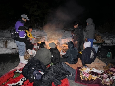 Foreign trainees and local residents spend the night around an open fire in a mountain in Suzu, Ishikawa Prefecture, after a strong quake hit the area on Jan. 1.
