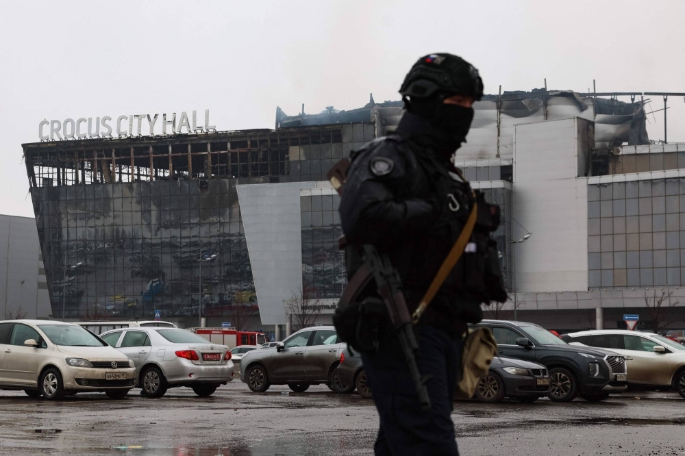 A law enforcement officer patrols the scene of the gun attack at the Crocus City Hall in Krasnogorsk, outside Moscow, on Saturday.