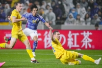 Satoshi Tanaka (second from left) scores Japan's second goal against Ukraine during the second half of their under-23 soccer friendly on Monday in Kitakyushu. | Kyodo