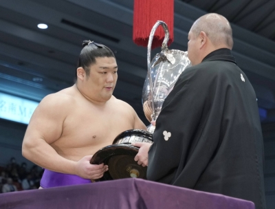 Takerufuji receives the Emperor's Cup at Edion Arena Osaka on Sunday.