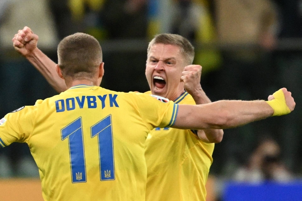Ukraine forward Artem Dovbyk (11) and midfielder Oleksandr Zinchenko celebrate after the team secured its berth in Euro 2024 with a win over Iceland, in Wroclaw, Poland, on Tuesday.