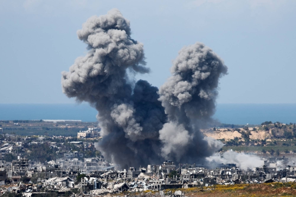 Smoke rises from the Gaza Strip during an explosion following an airstrike on Saturday. The war in Gaza has not stopped and Hamas has not freed anyone despite the adoption of a U.N. resolution on Monday demanding a cease-fire and the release of hostages.