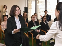 Liliia Skorohodova receives her diploma at the Japan University of Economics in Dazaifu, Fukuoka Prefecture, on March 15. | Kyodo
