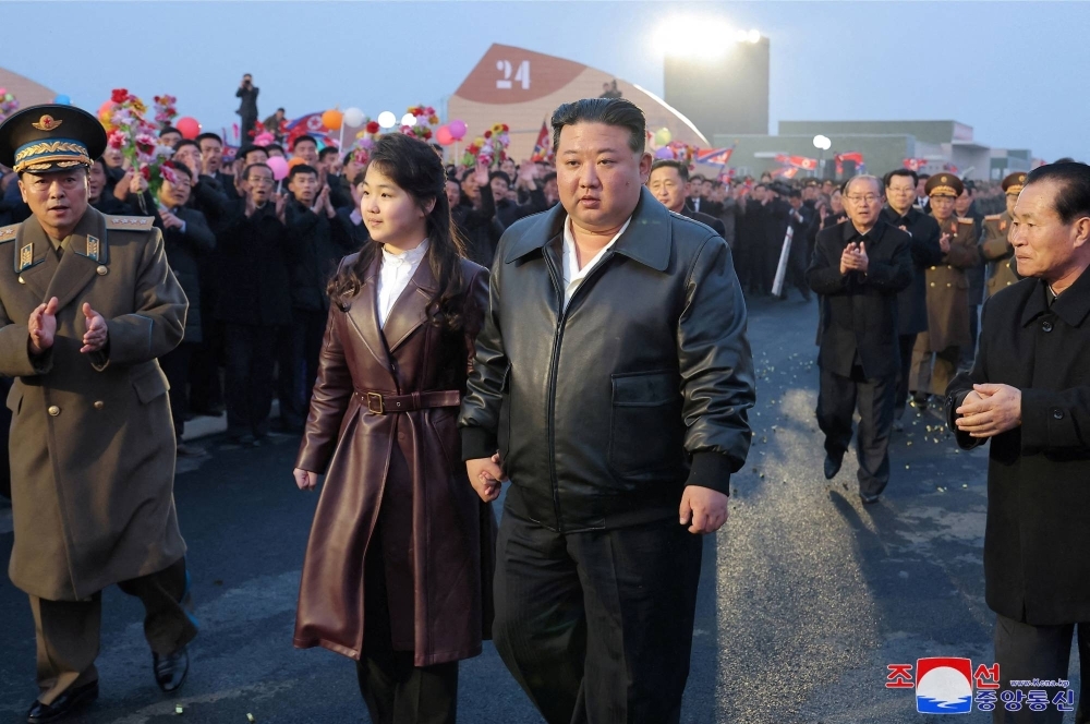 Kim Jong Un and his daughter Kim Ju Ae attend the opening ceremony of the Gangdong Greenhouse in North Korea in this picture released on March 16.