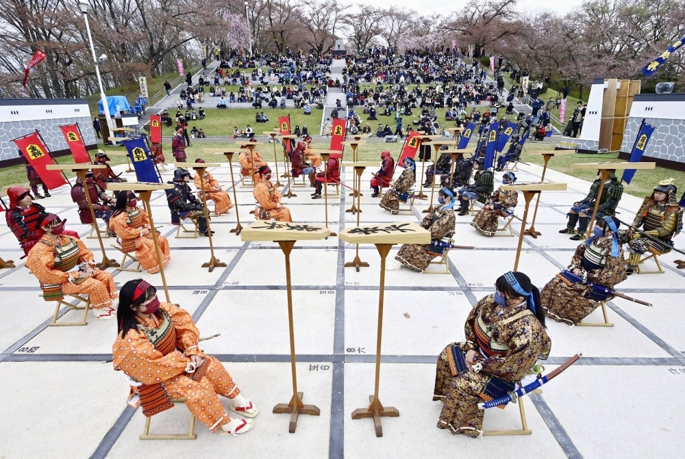 A shogi board game with human pieces is played out in Tendo, Yamagata Prefecture, last year. 
