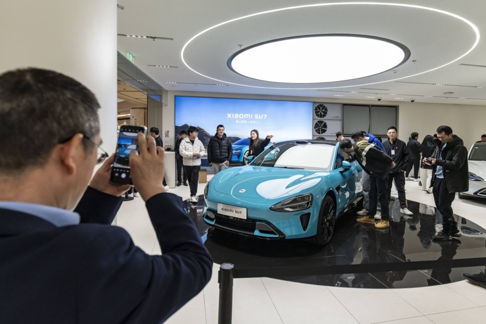 A Xiaomi SU7 electric vehicle on display at one of the company's stores in Shanghai on Tuesday. Xiaomi declared its ambition for the SU7 to become one of China's three best-selling luxury electric vehicle models, sounding a challenge to Tesla and other rivals in an increasingly crowded market.