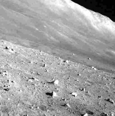 A black-and-white photo of the rocky surface of a crater transmitted by Japan's unmanned moon lander