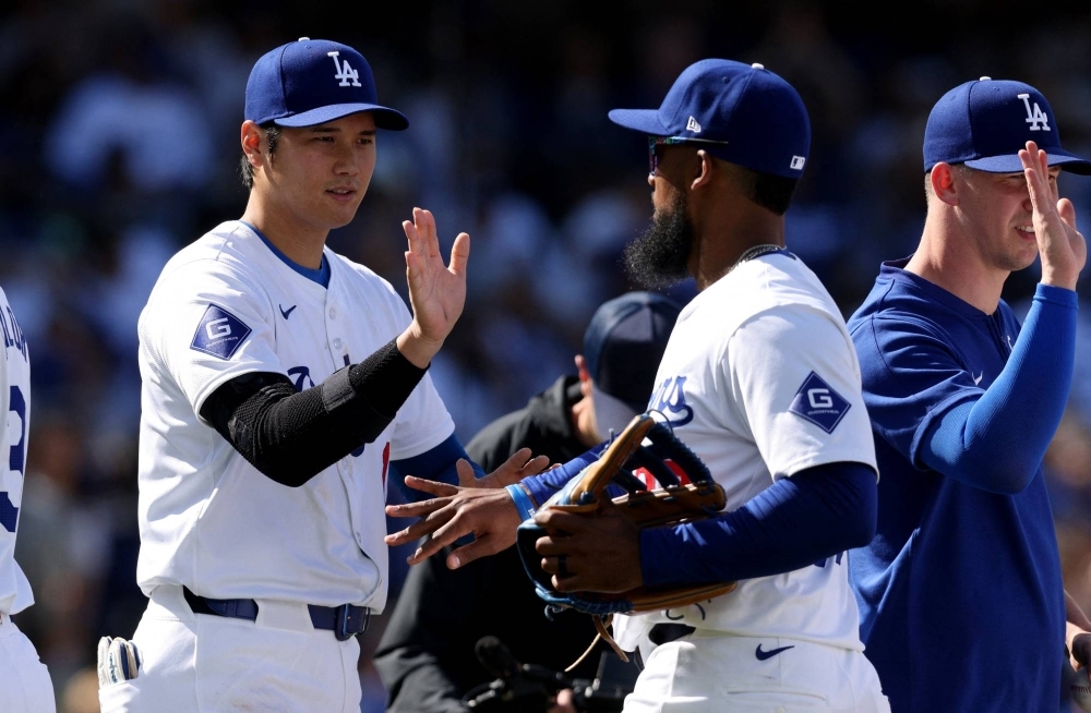 Dodgers designated hitter Shohei Ohtani celebrates with outfielder Teoscar Hernandez after an opening day win against the St. Louis Cardinals at Dodger Stadium in Los Angeles on Thursday.