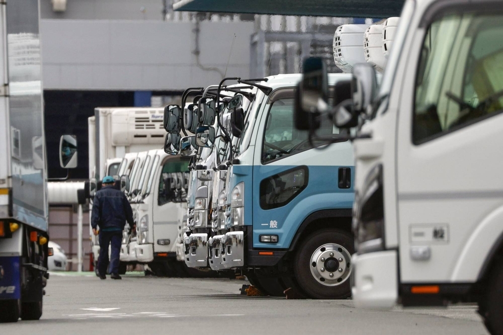 Trucks at a logistics center in the city of Fukuoka in December. Nomura Research Institute estimates that a shortage of truck drivers will lead to 35% of goods not being transported around the country in 2030, with the ratio seen to be higher in more remote regions.