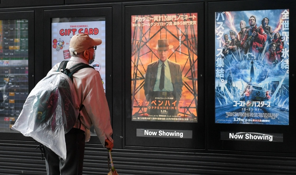 A poster for "Oppenheimer" is displayed at a theater in Tokyo's Shinjuku Ward on Friday. The film's Japan debut came eight months after its global release.